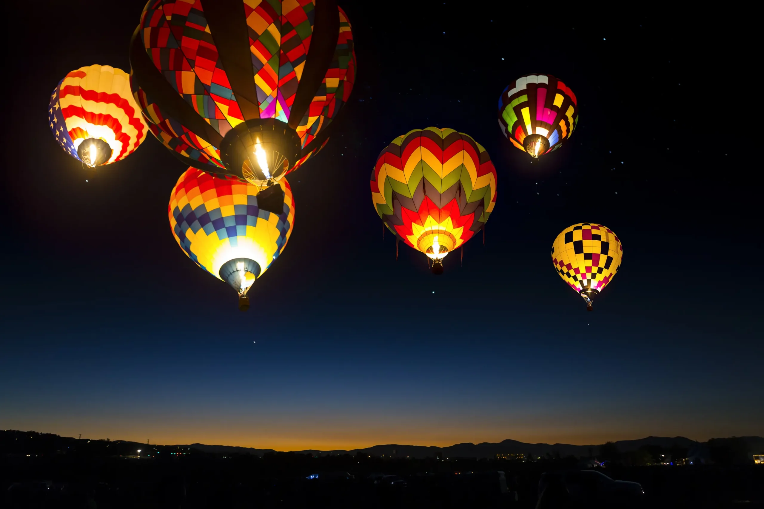 Hot air balloons launching at the Reno Balloon Races in Reno Nevada during early morning dawn patrol at Rancho San Rafael Regional Park