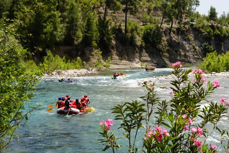 Rafters navigating rapids on the Truckee River near downtown Reno with riverwalk scenery.