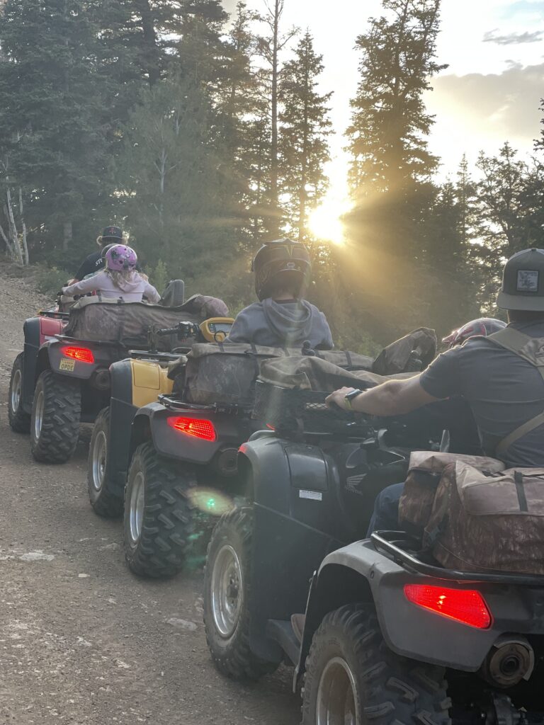 An ATV rider traveling across open desert terrain near Reno Tahoe, with mountains in the background and wide open riding space in Northern Nevada.